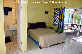 inside the Beachfront Studio Unit at Tianas showing sleeping area and bathroom entrance
