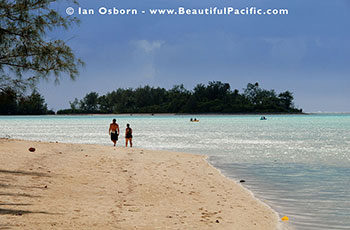 Couple walking along Muri Beach